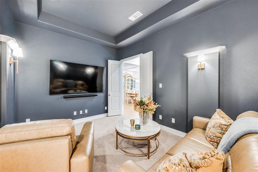 2390 Red Cedar Trail Prosper, TX 75078 - Photo 7 of 40 a living room with furniture and a flat screen tv
