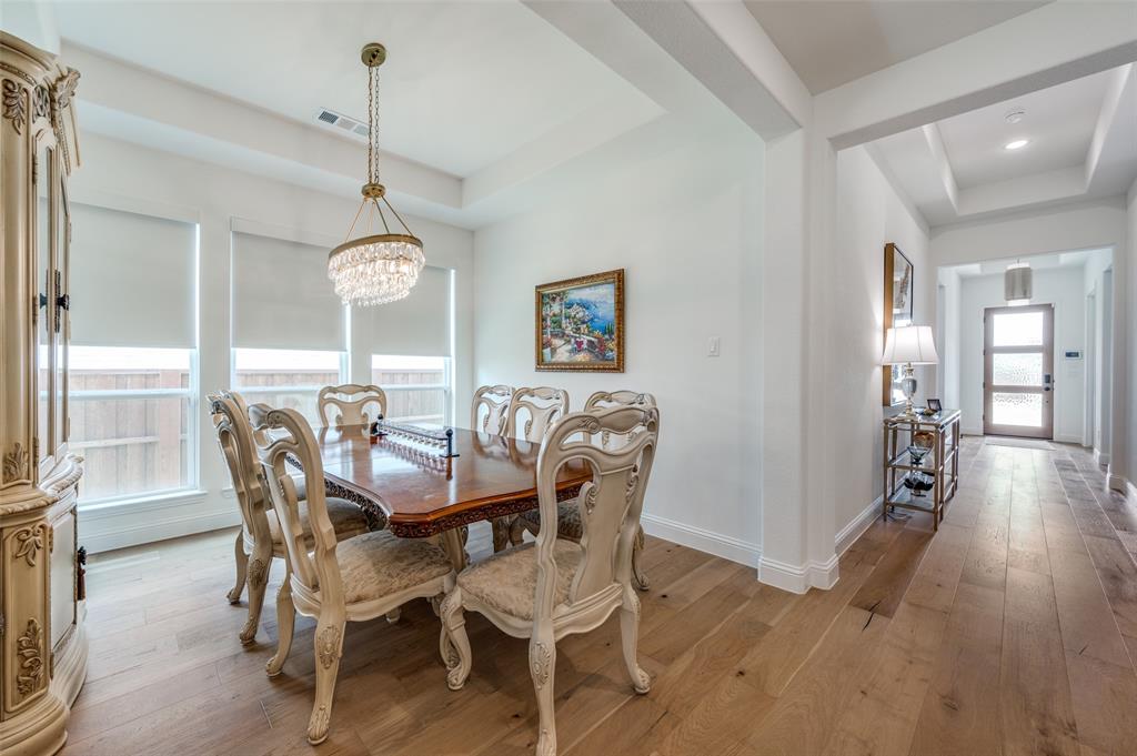 2390 Red Cedar Trail Prosper, TX 75078 - Photo 9 of 40 a view of a dining room with furniture window and wooden floor