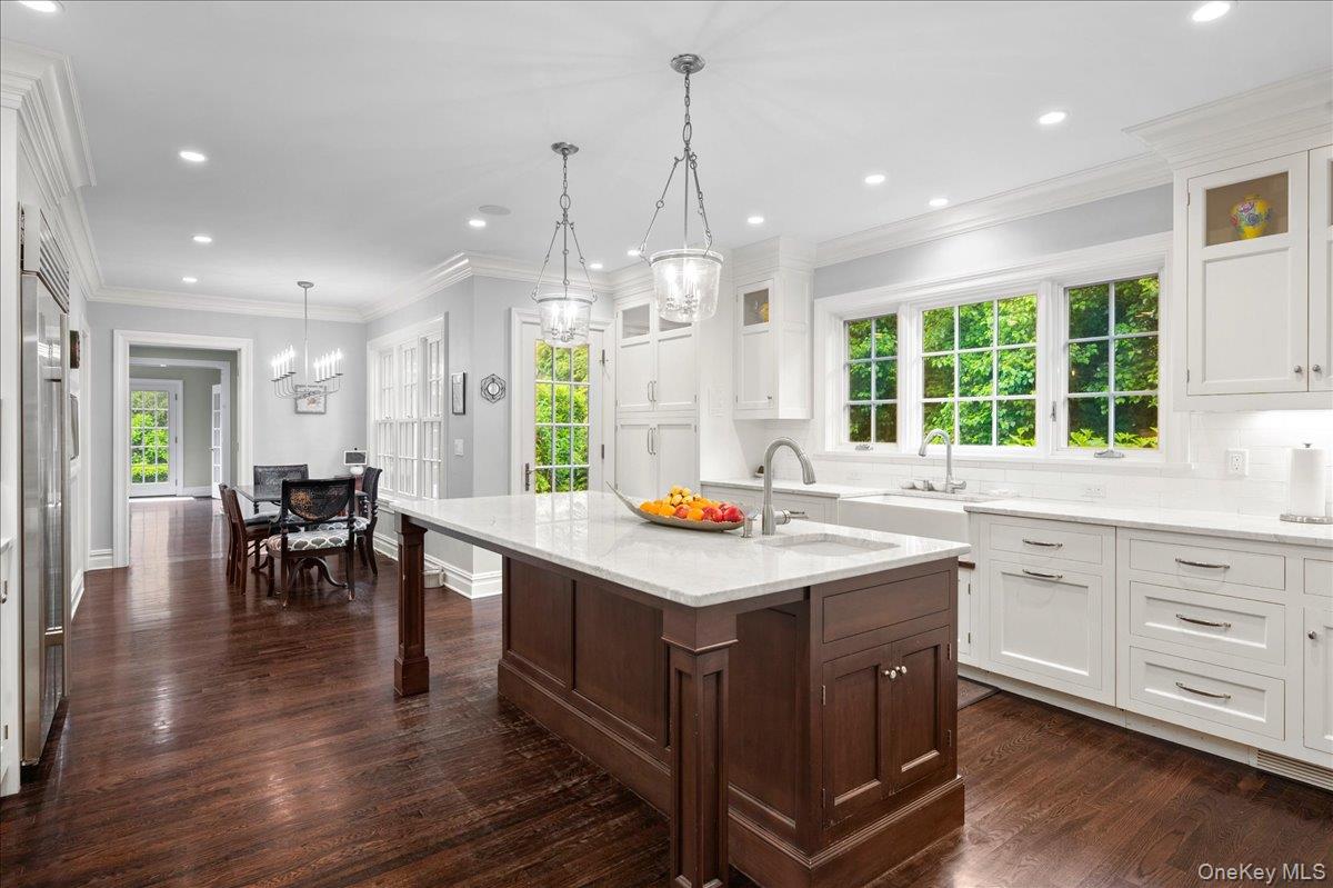 7 Harcourt Road Scarsdale, NY 10583 - Photo 5 of 34 a kitchen with center island table and chairs