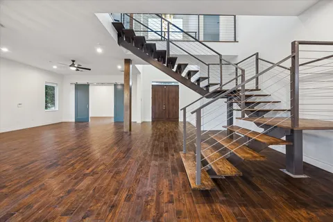 a view of entryway and hall with wooden floor