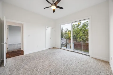 a view of a livingroom with a ceiling fan and window