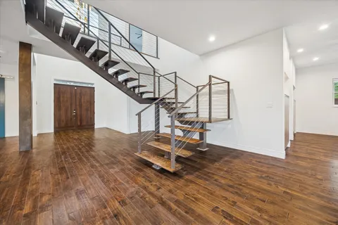 a view of a room with wooden floor and stairs