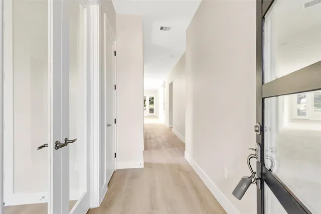 a view of a hallway with a wooden floor