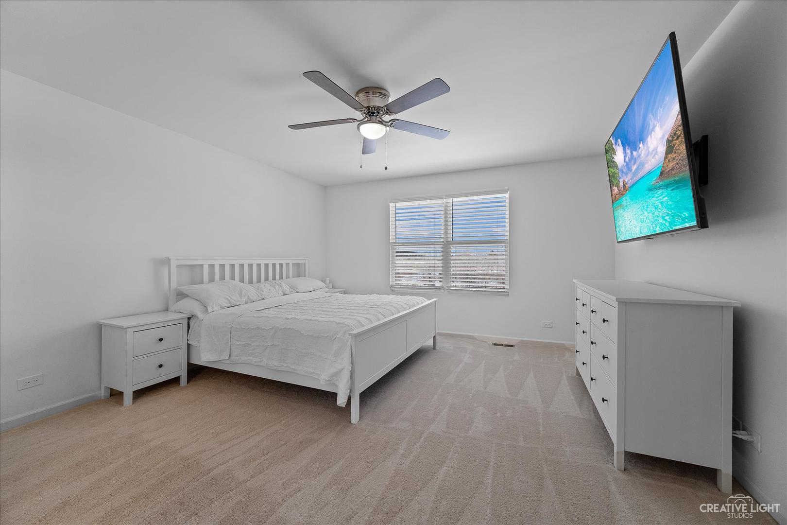 4341 Rudyard Kipling Road Elgin, IL 60124 - Photo 14 of 30 a spacious bedroom with a bed and a window