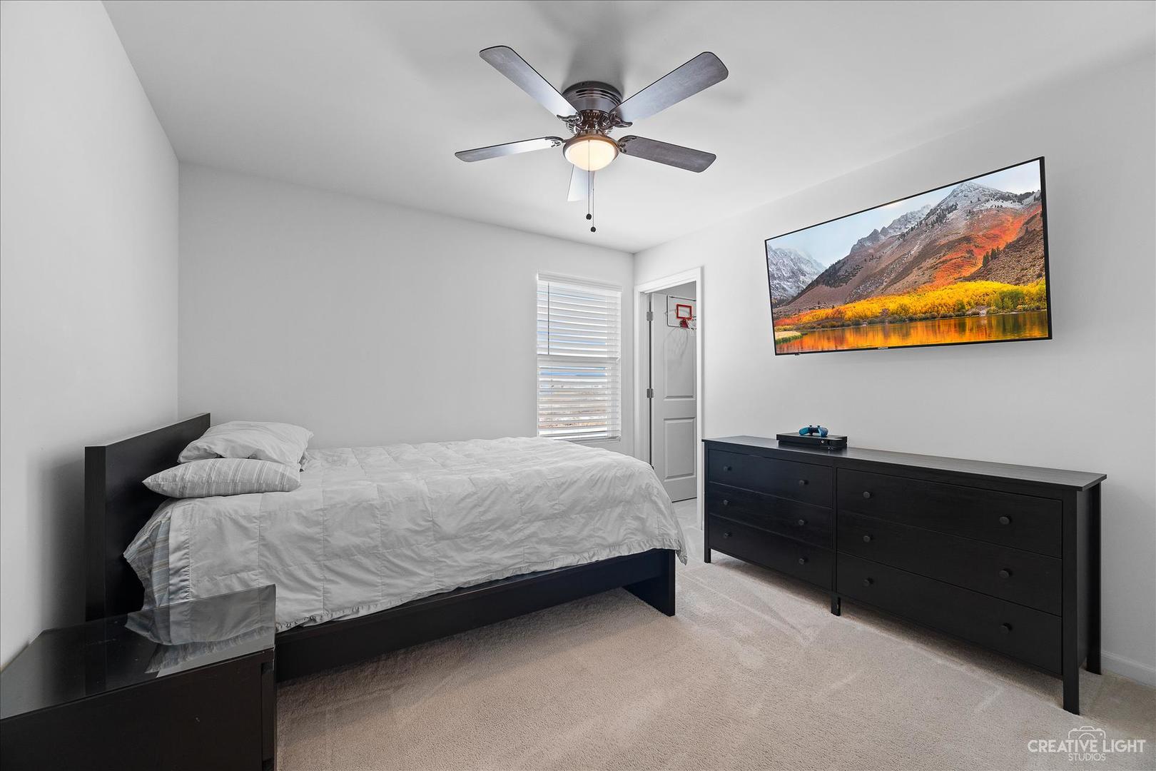 4341 Rudyard Kipling Road Elgin, IL 60124 - Photo 17 of 30 a bedroom with a bed and a chandelier