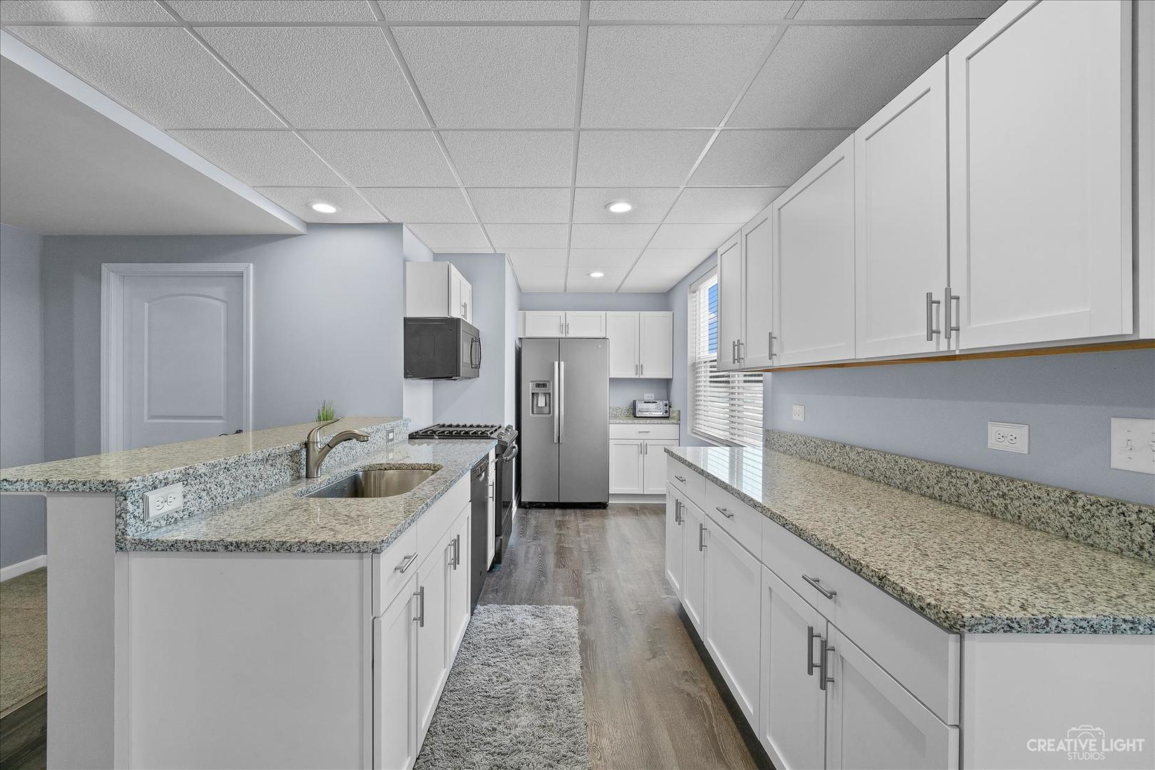 4341 Rudyard Kipling Road Elgin, IL 60124 - Photo 23 of 30 a kitchen with granite countertop a sink and cabinets