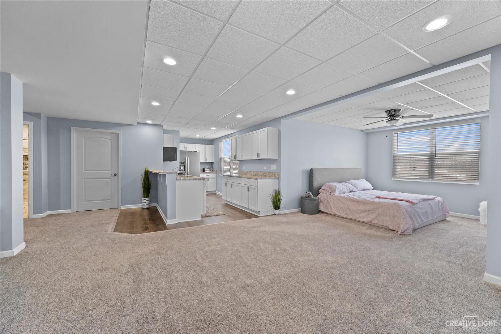 4341 Rudyard Kipling Road Elgin, IL 60124 - Photo 24 of 30 a spacious bedroom with a bed and a large window
