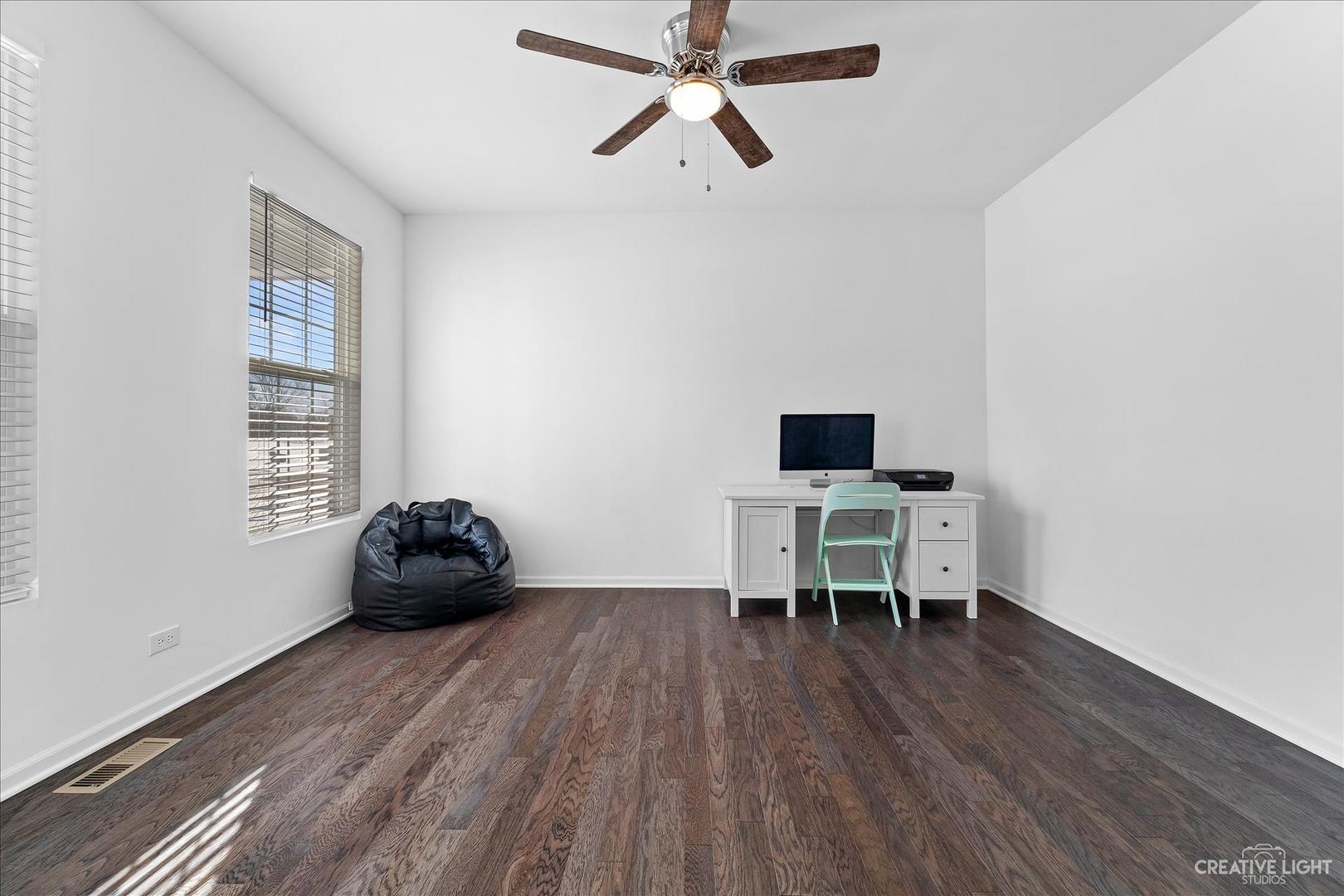4341 Rudyard Kipling Road Elgin, IL 60124 - Photo 4 of 30 a work room with wooden floor and a window