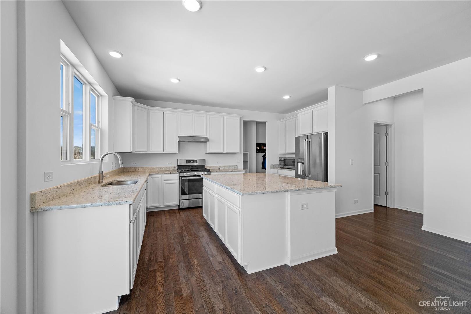 4341 Rudyard Kipling Road Elgin, IL 60124 - Photo 8 of 30 a large kitchen with stainless steel appliances sink a microwave and cabinets