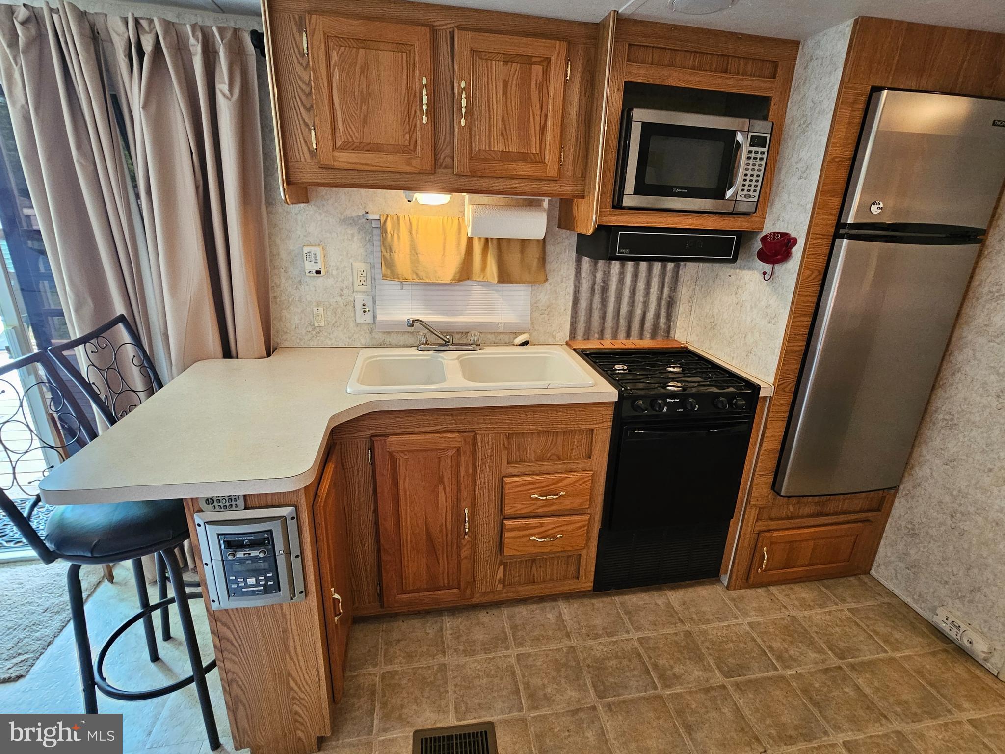 21 Campfire Boulevard Falling Waters, WV 25419 - Photo 14 of 30 a kitchen with a refrigerator stove and cabinets