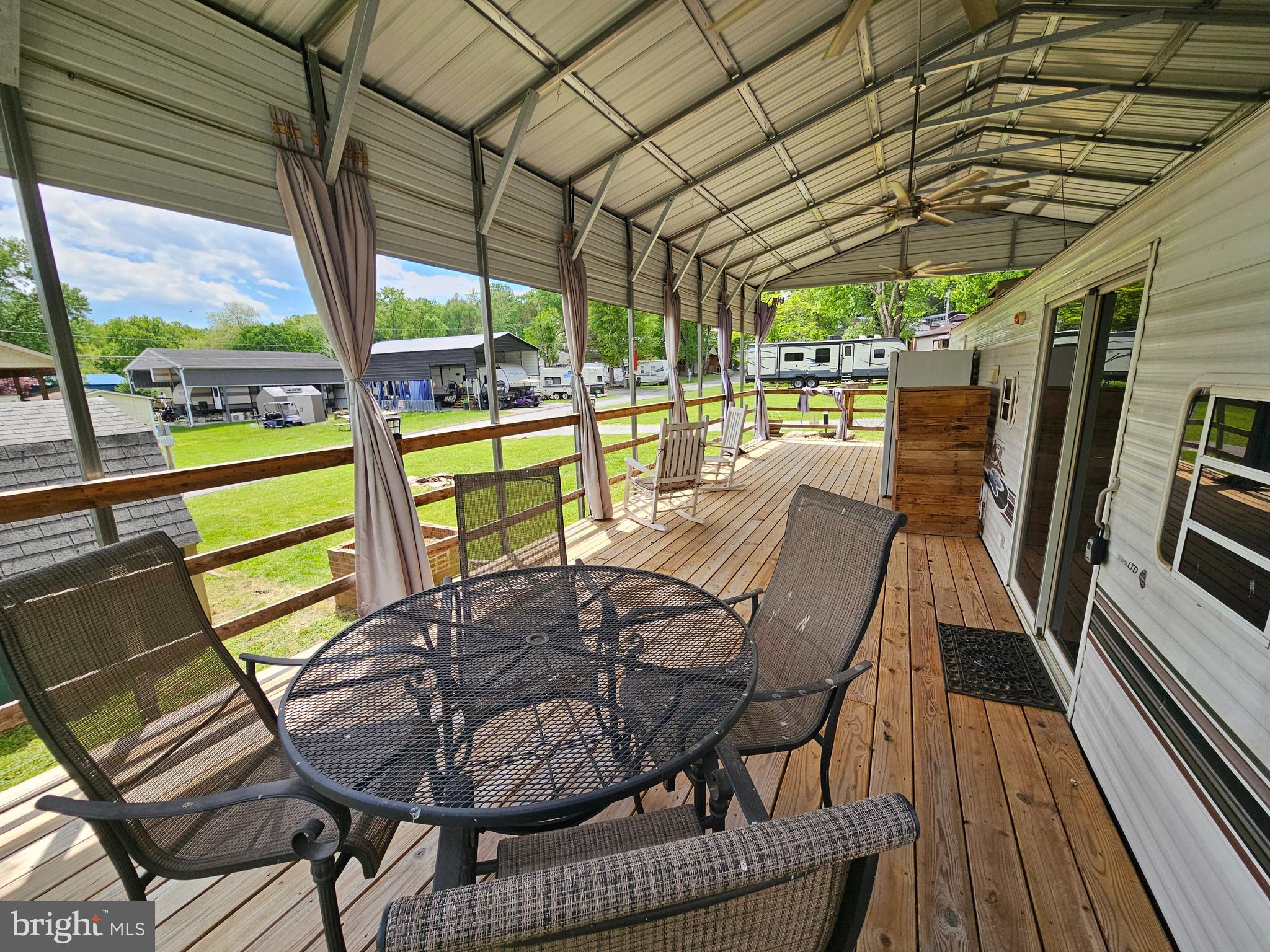 21 Campfire Boulevard Falling Waters, WV 25419 - Photo 6 of 30 a view of a chairs and table in the balcony
