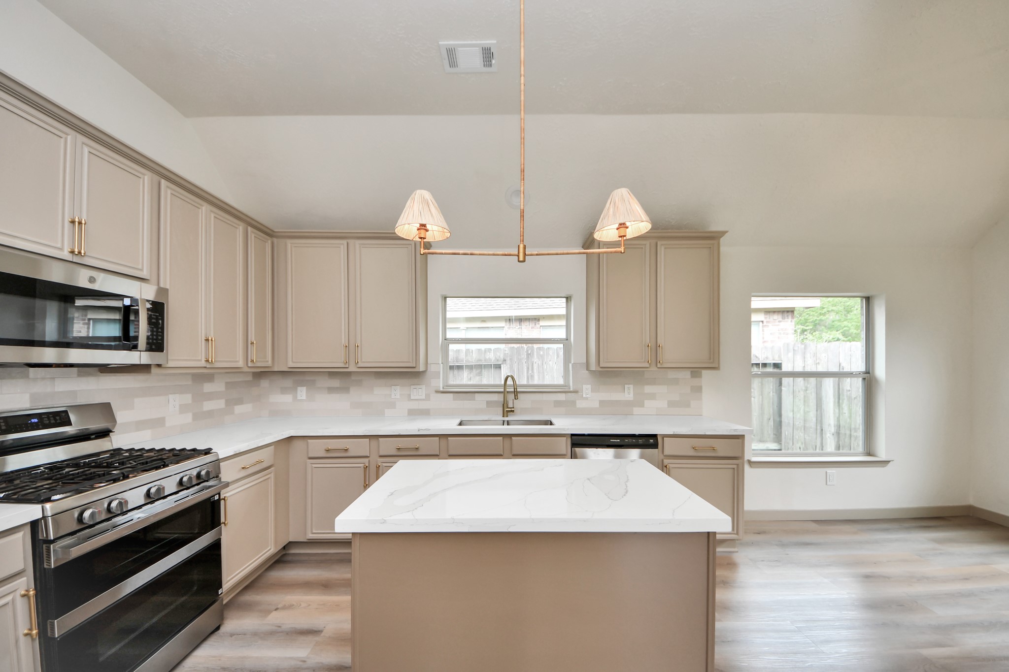 14423 Gadwall Court Houston, TX 77044 - Photo 29 of 42 a kitchen with granite countertop a sink a stove and cabinets