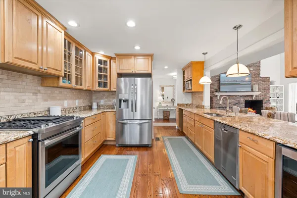 a living room with lots of furniture and a view of kitchen