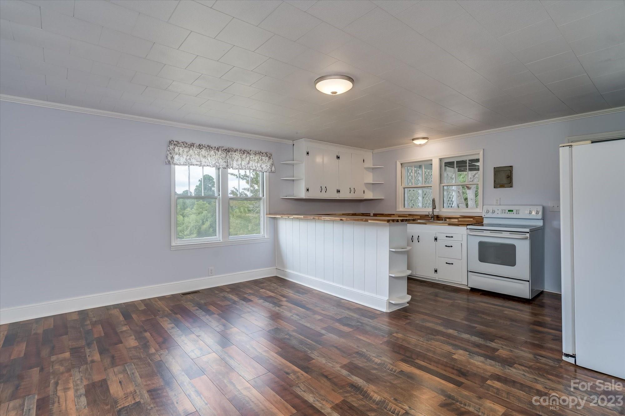 2540 Maple Creek Road Rutherfordton, NC 28139 - Photo 13 of 48 a kitchen with stainless steel appliances granite countertop a stove a sink dishwasher and a refrigerator with wooden floor