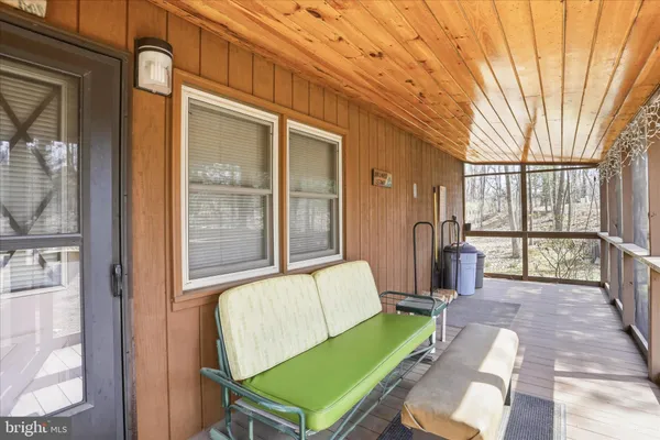 a balcony with furniture and a potted plant