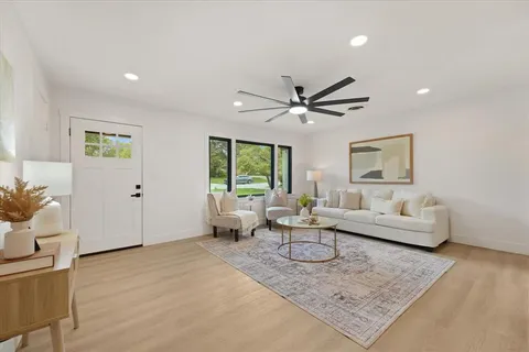 a living room with furniture and a large window