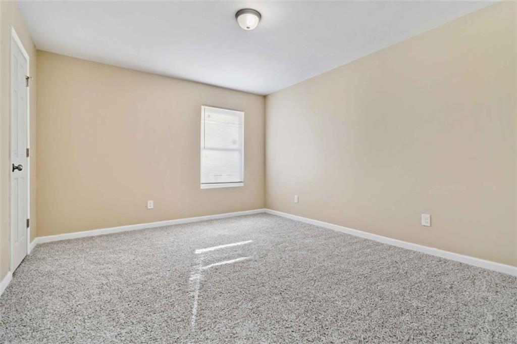 2340 Beaver Ruin Road, Unit 16 Norcross, GA 30071 - Photo 15 of 28 an empty room with windows and closet
