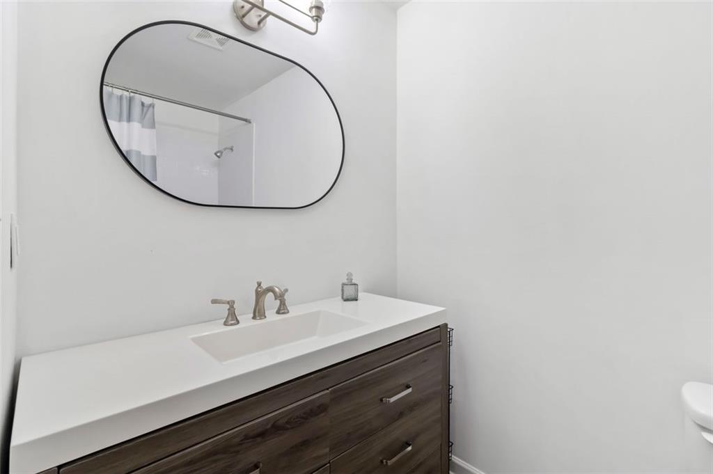 2340 Beaver Ruin Road, Unit 16 Norcross, GA 30071 - Photo 18 of 28 a bathroom with a sink and a mirror