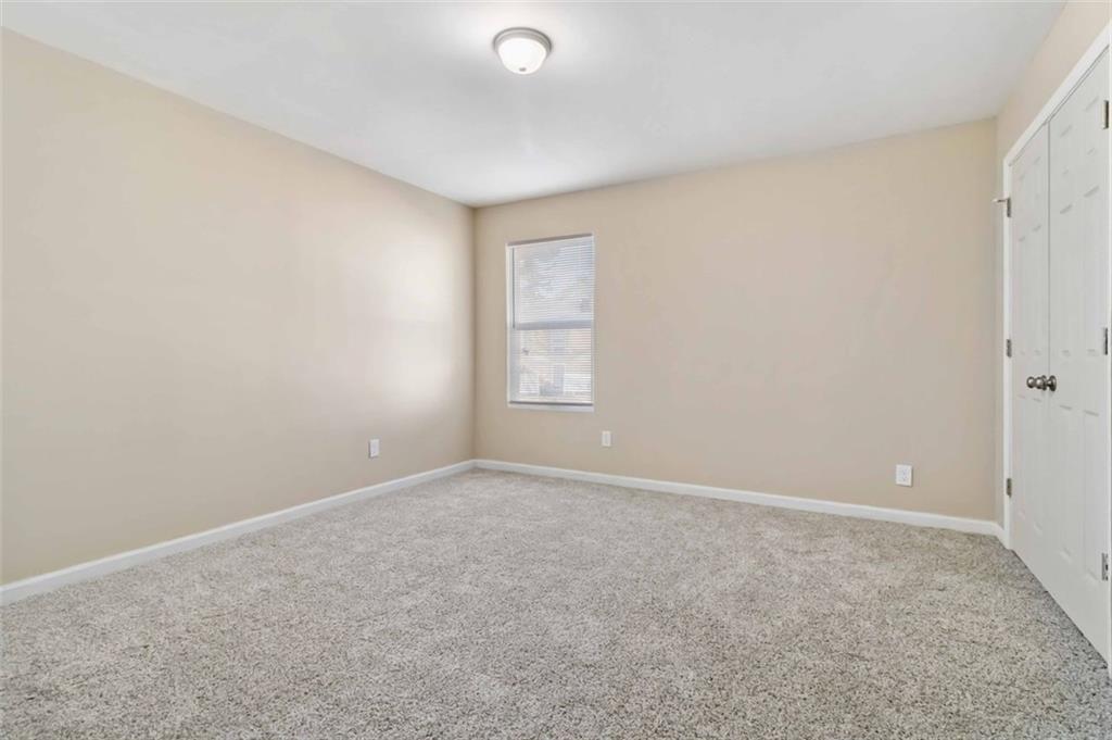 2340 Beaver Ruin Road, Unit 16 Norcross, GA 30071 - Photo 20 of 28 a view of an empty room with a window