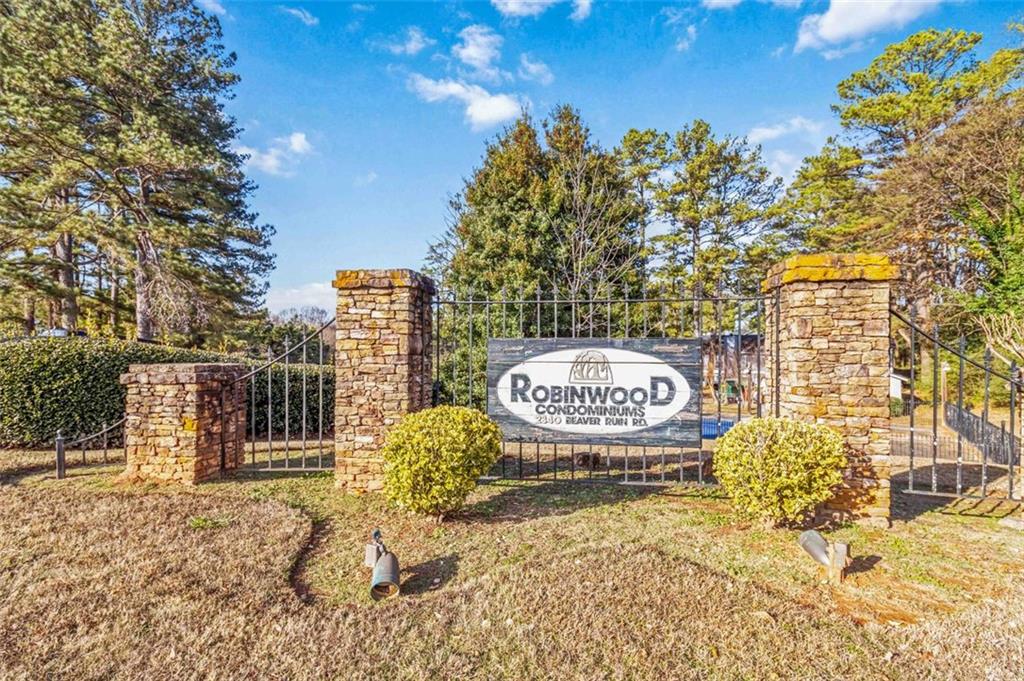 2340 Beaver Ruin Road, Unit 16 Norcross, GA 30071 - Photo 28 of 28 a sign that is sitting on a brick wall