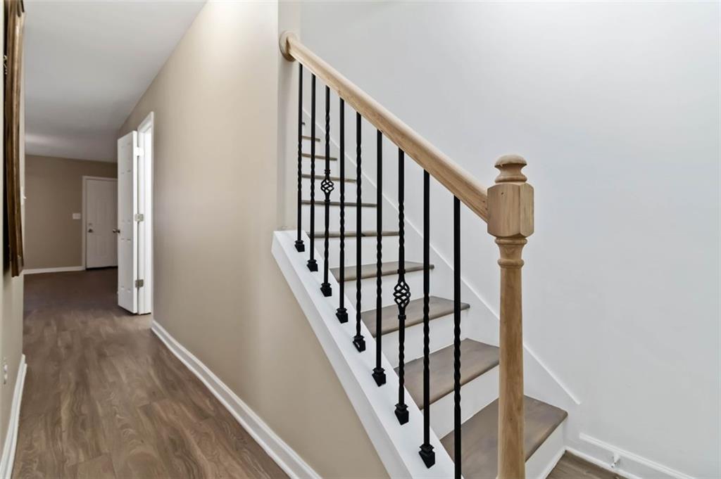 2340 Beaver Ruin Road, Unit 16 Norcross, GA 30071 - Photo 4 of 28 a view of staircase with wooden floor and white walls