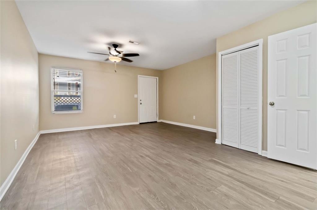 2340 Beaver Ruin Road, Unit 16 Norcross, GA 30071 - Photo 7 of 28 wooden floor in an empty room with a window