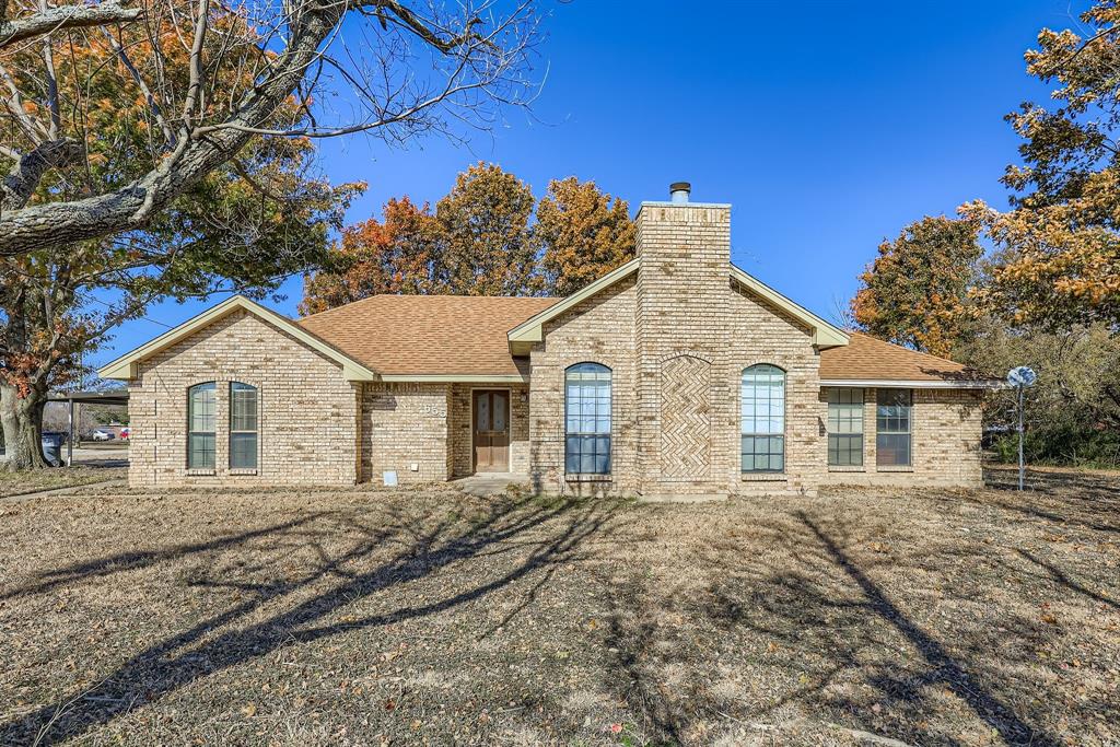Brick home with fireplace sitting on nearly 1 acre, trees surrounding. 