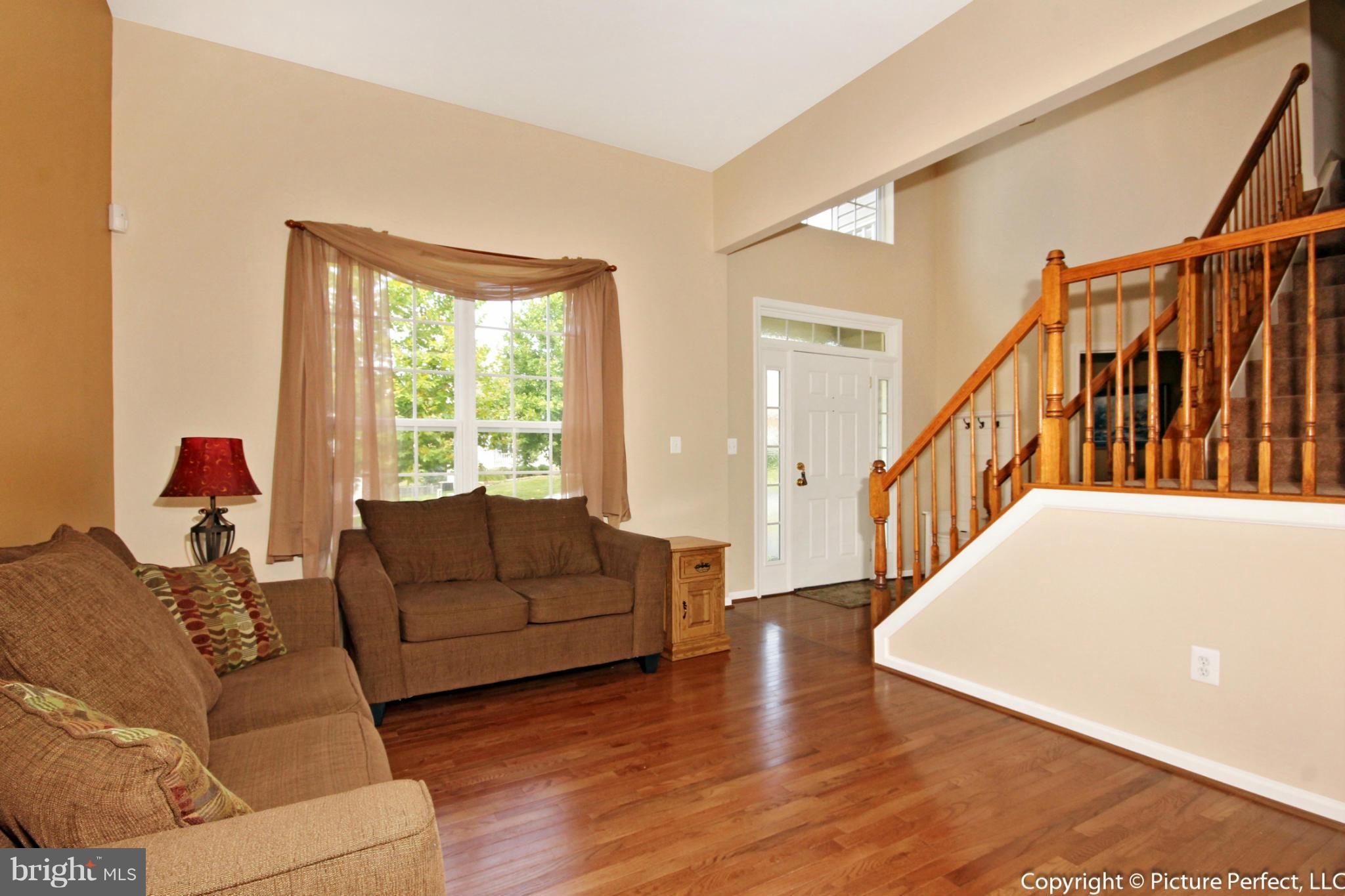 14308 Autumn Crest Road Boyds, MD 20841 - Photo 7 of 21 a living room with furniture or stairs and a wooden floor