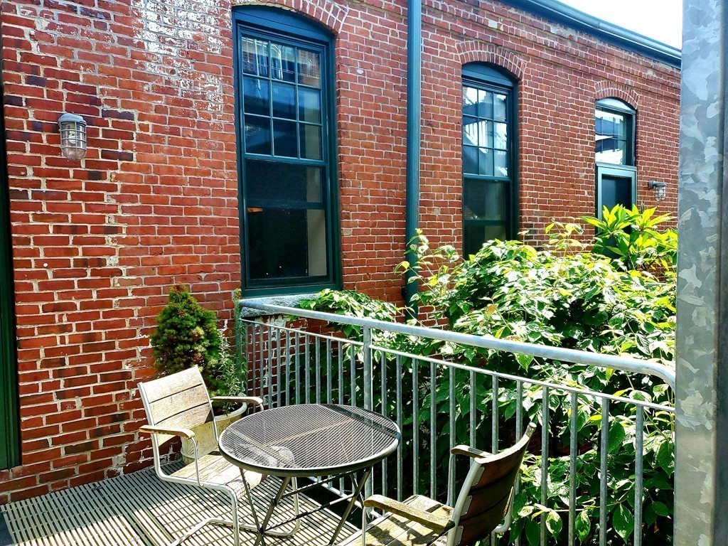 60 Dudley Street, Unit 22 Chelsea, MA 02150 - Photo 12 of 15 a view of a chair and table in backyard