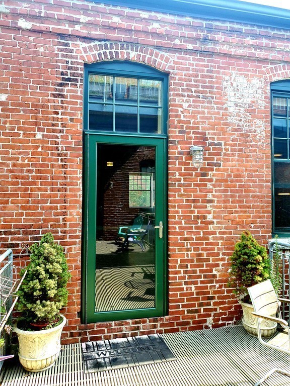 60 Dudley Street, Unit 22 Chelsea, MA 02150 - Photo 2 of 15 a view of a door of a brick house with a large window
