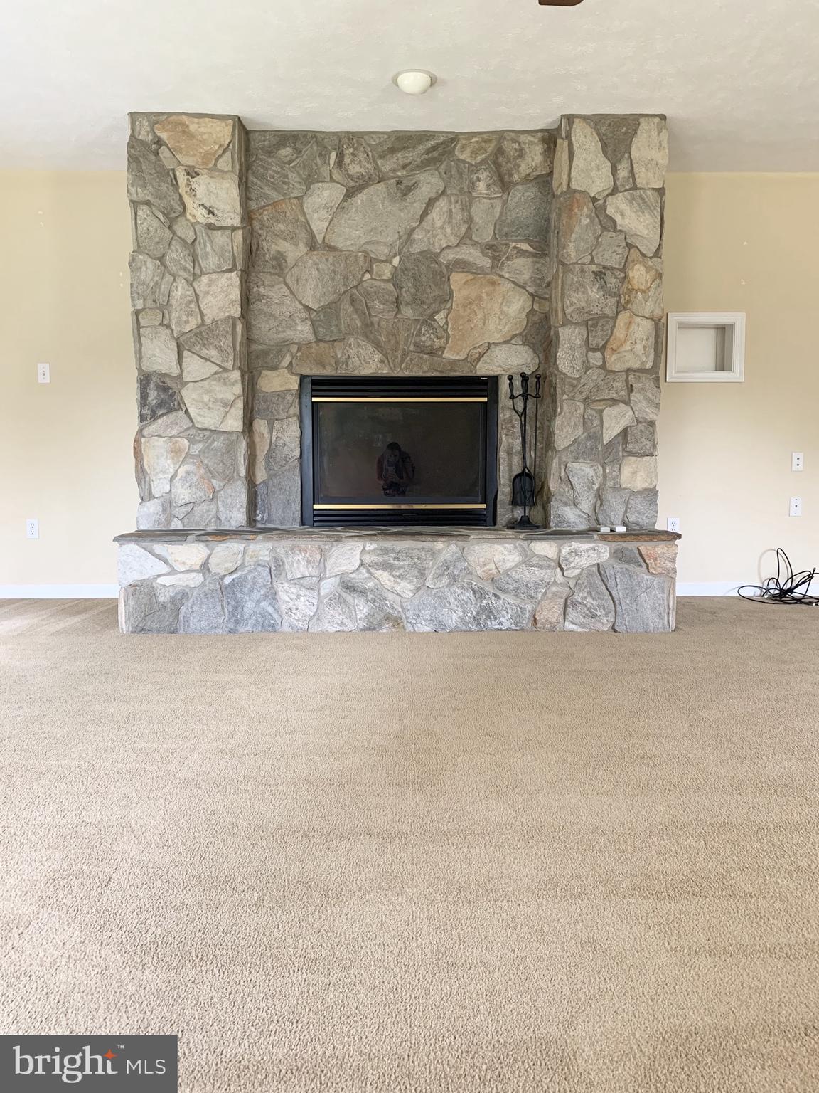 8474 Leeds Manor Road Warrenton, VA 20186 - Photo 14 of 38 Gas fireplace in primary bedroom suite