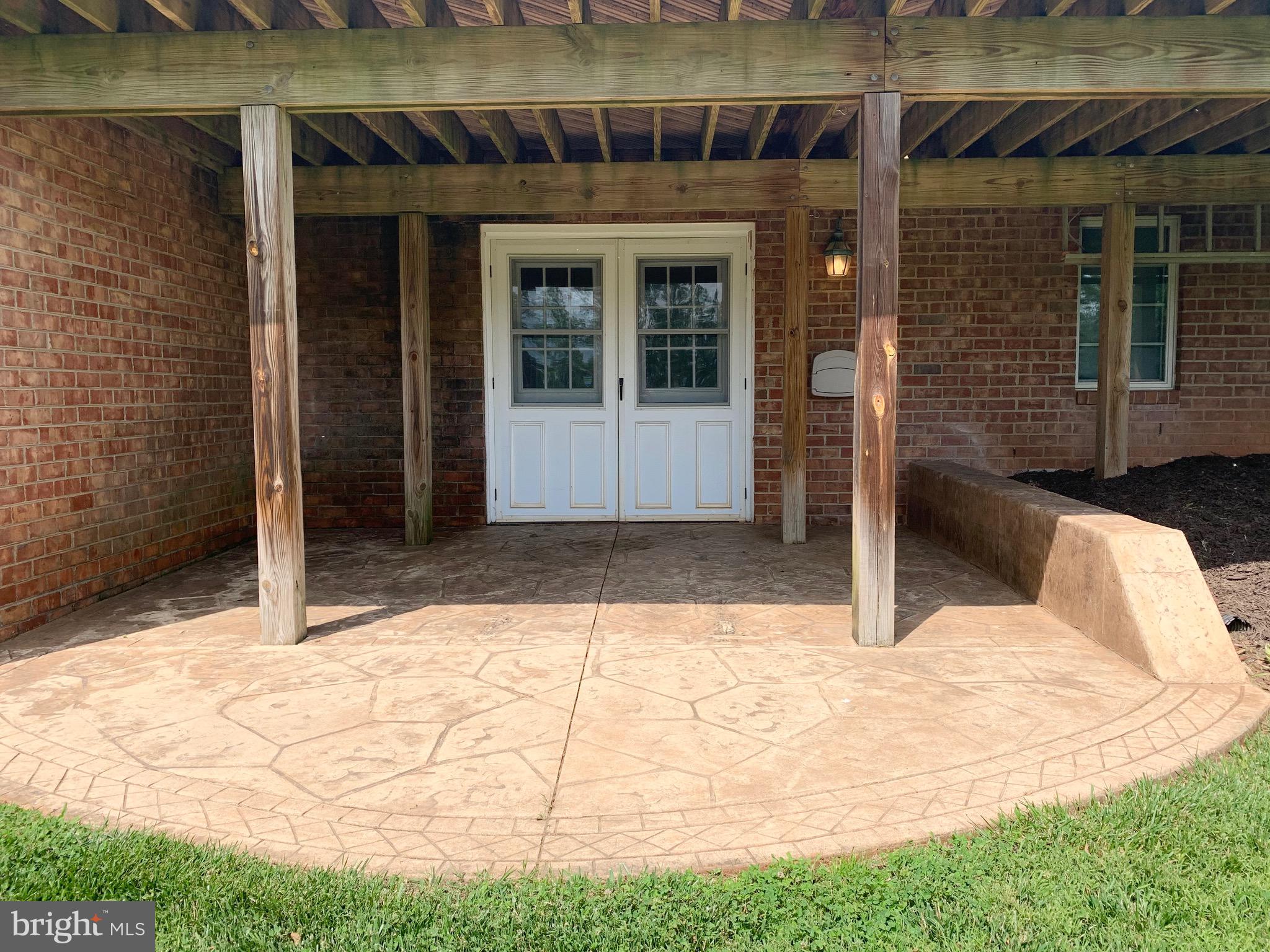 8474 Leeds Manor Road Warrenton, VA 20186 - Photo 30 of 38 rear stamped concrete patio