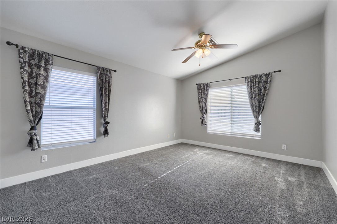 5985 High Steed Street, Unit 101 Henderson, NV 89011 - Photo 25 of 38 A well-lit room boasts vaulted ceilings and ample natural illumination from multiple windows.