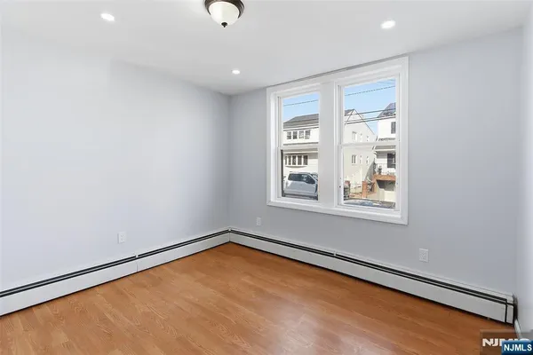 a view of a room with wooden floor