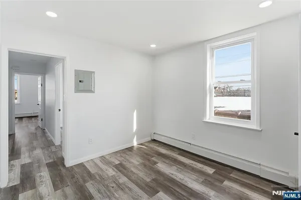 a view of a room with wooden floor and a window