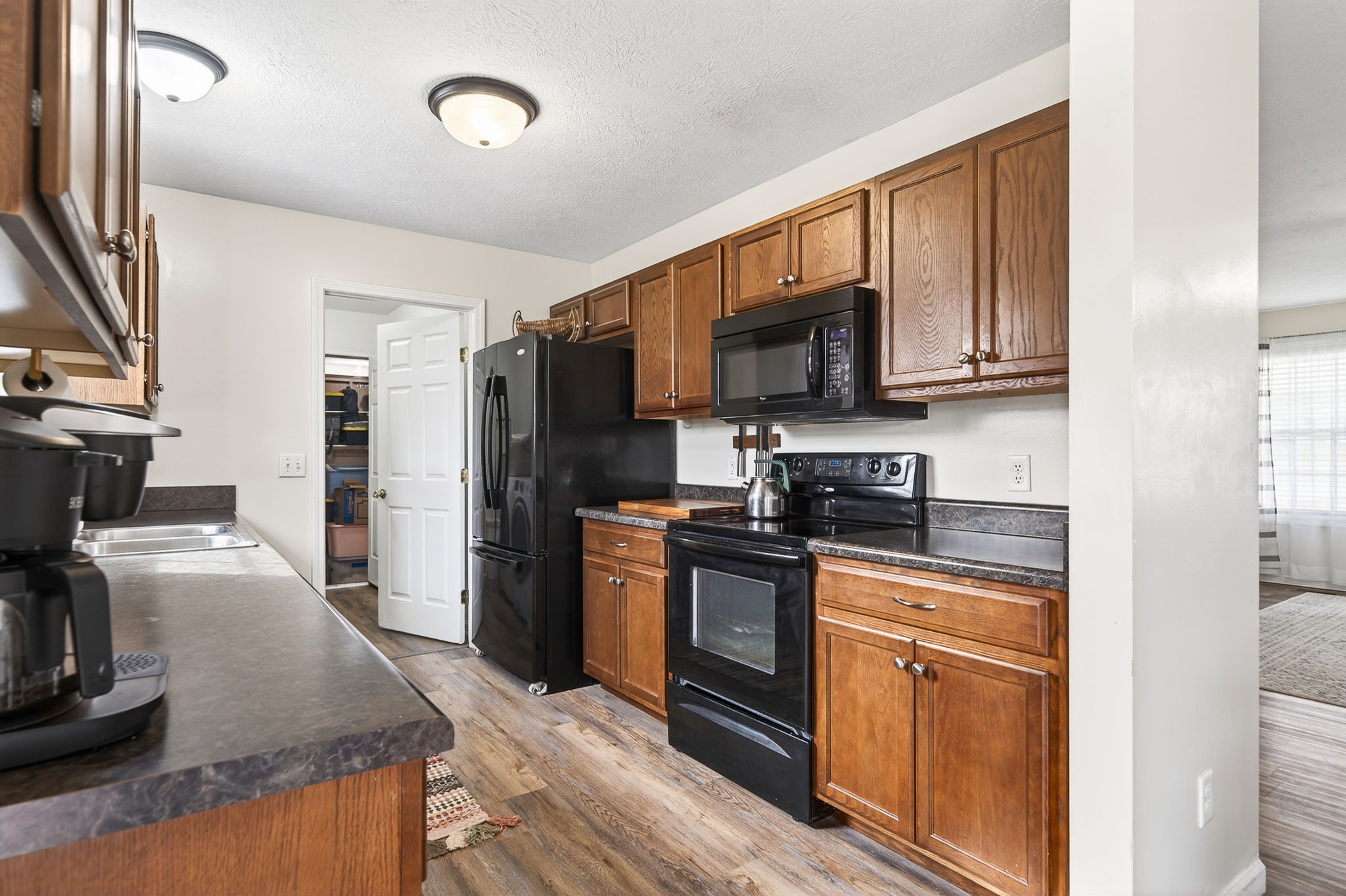 4535 Ewing Drive Baxter, TN 38544 - Photo 8 of 32 a kitchen with kitchen island granite countertop a stove sink and refrigerator