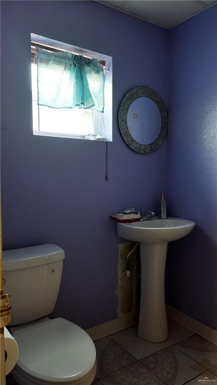 905 West Bowe Street Pharr, TX 78577 - Photo 11 of 12 a bathroom with a toilet sink and mirror