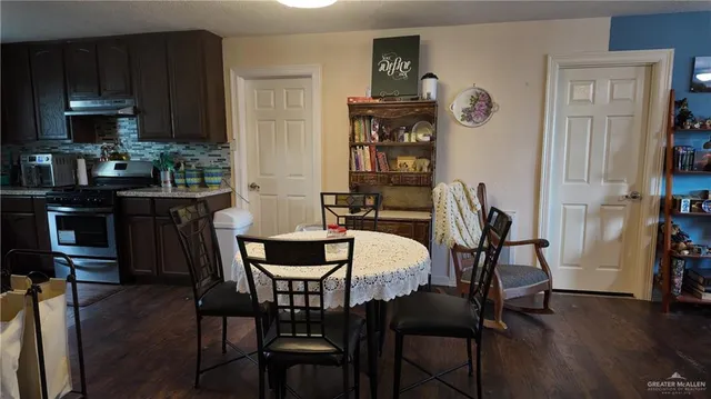 a dining room with furniture and wooden floor