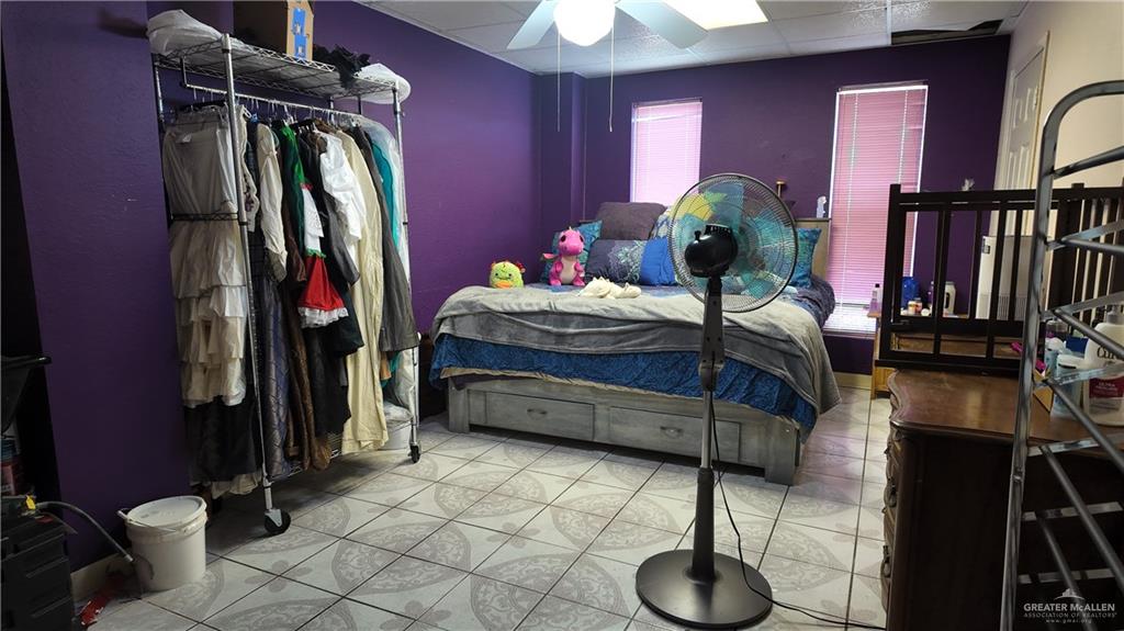 905 West Bowe Street Pharr, TX 78577 - Photo 9 of 12 a bedroom with a bed and a chandelier