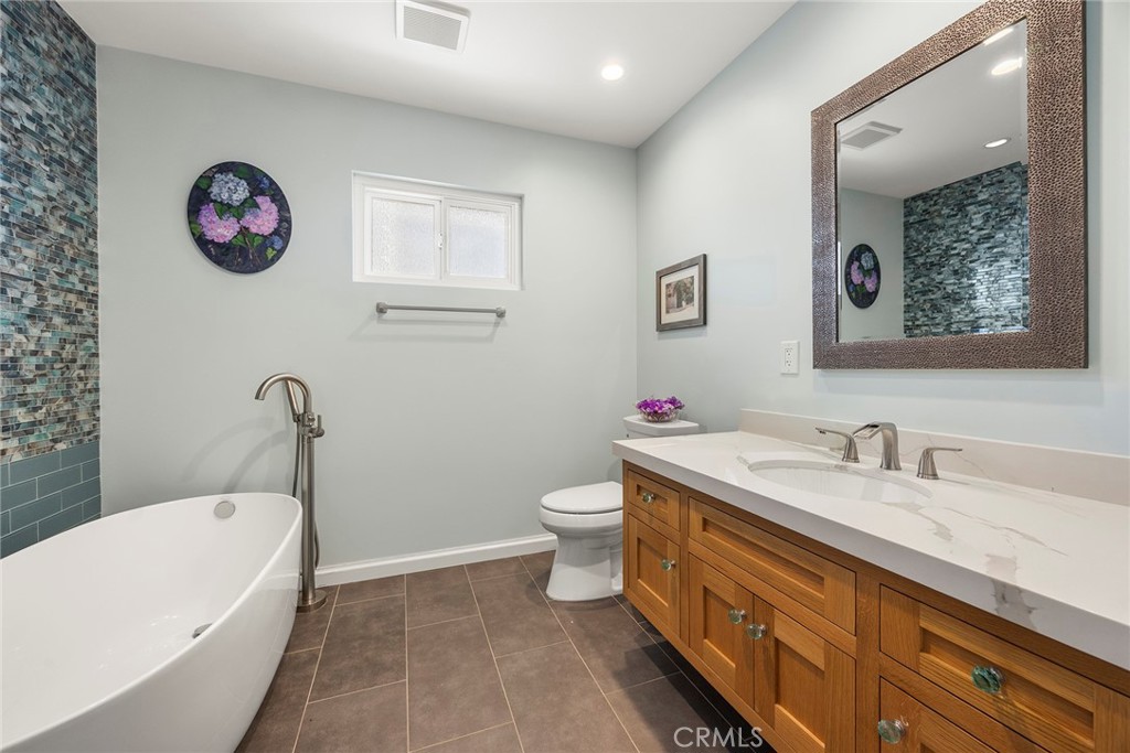 1019 Eadington Drive Brea, CA 92821 - Photo 12 of 22 a bathroom with a granite countertop sink mirror vanity and toilet