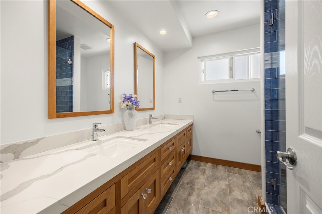 1019 Eadington Drive Brea, CA 92821 - Photo 16 of 22 a bathroom with a double vanity sink and a mirror