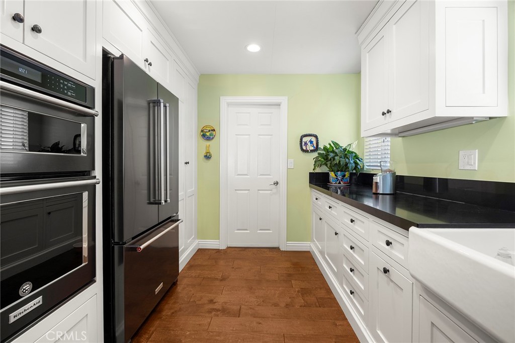 1019 Eadington Drive Brea, CA 92821 - Photo 8 of 22 a kitchen with granite countertop a refrigerator and a sink
