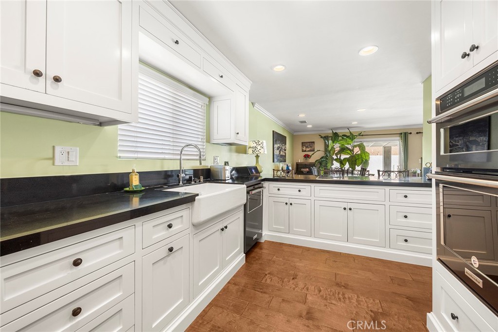 1019 Eadington Drive Brea, CA 92821 - Photo 9 of 22 a kitchen with granite countertop white cabinets and white appliances