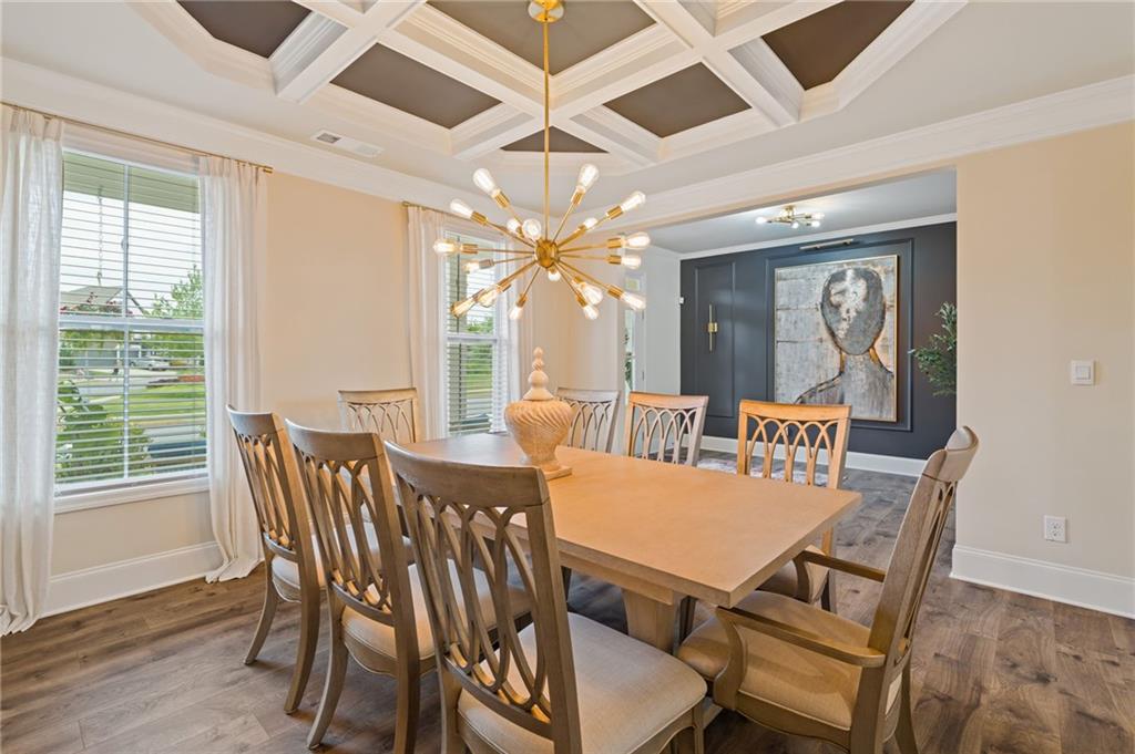 304 Ellenton Place Canton, GA 30115 - Photo 16 of 76 a view of a dining room with furniture window and wooden floor