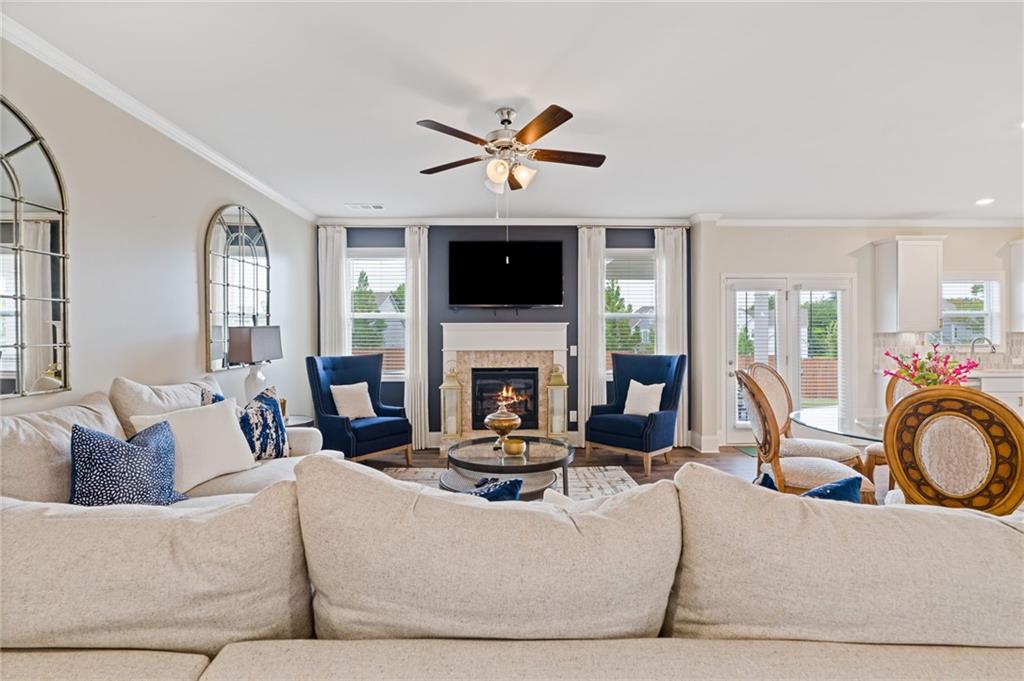 304 Ellenton Place Canton, GA 30115 - Photo 18 of 76 a living room with furniture a fireplace and a flat screen tv