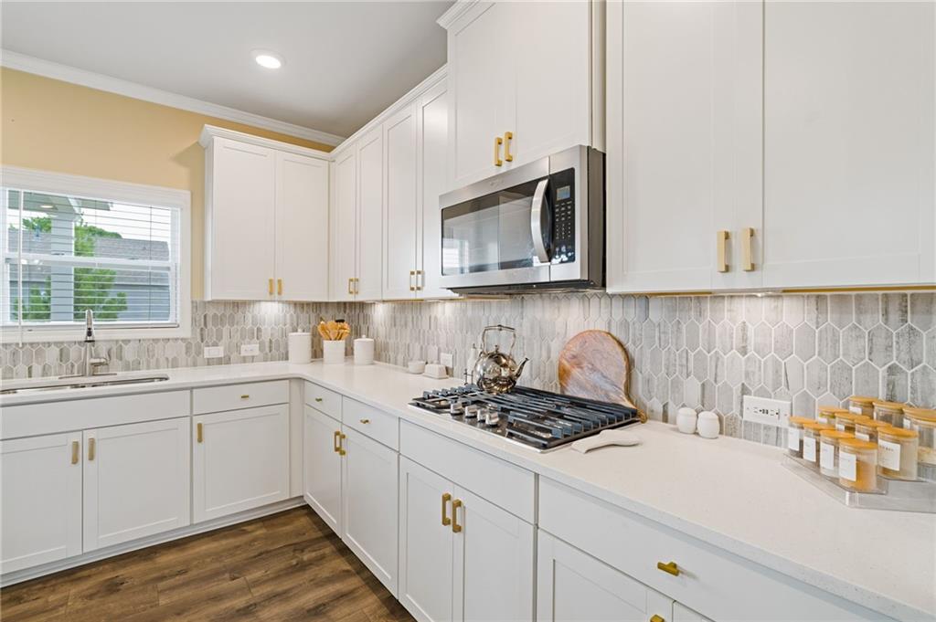 304 Ellenton Place Canton, GA 30115 - Photo 28 of 76 a kitchen with stainless steel appliances granite countertop a sink a stove and cabinets
