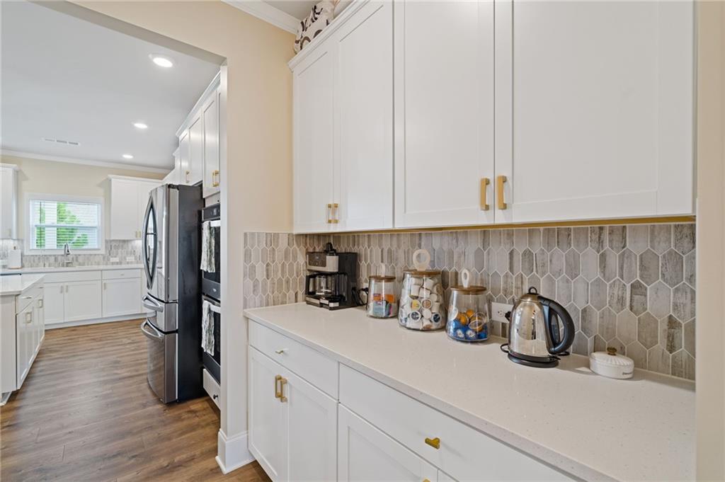 304 Ellenton Place Canton, GA 30115 - Photo 33 of 76 a kitchen with refrigerator and cabinets