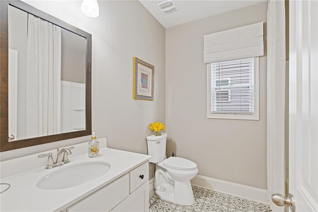 304 Ellenton Place Canton, GA 30115 - Photo 36 of 76 a bathroom with a sink a toilet and a window
