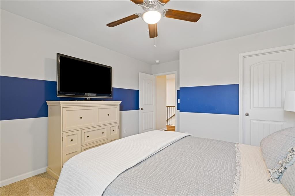 304 Ellenton Place Canton, GA 30115 - Photo 44 of 76 a bedroom with a bed and a flat screen tv