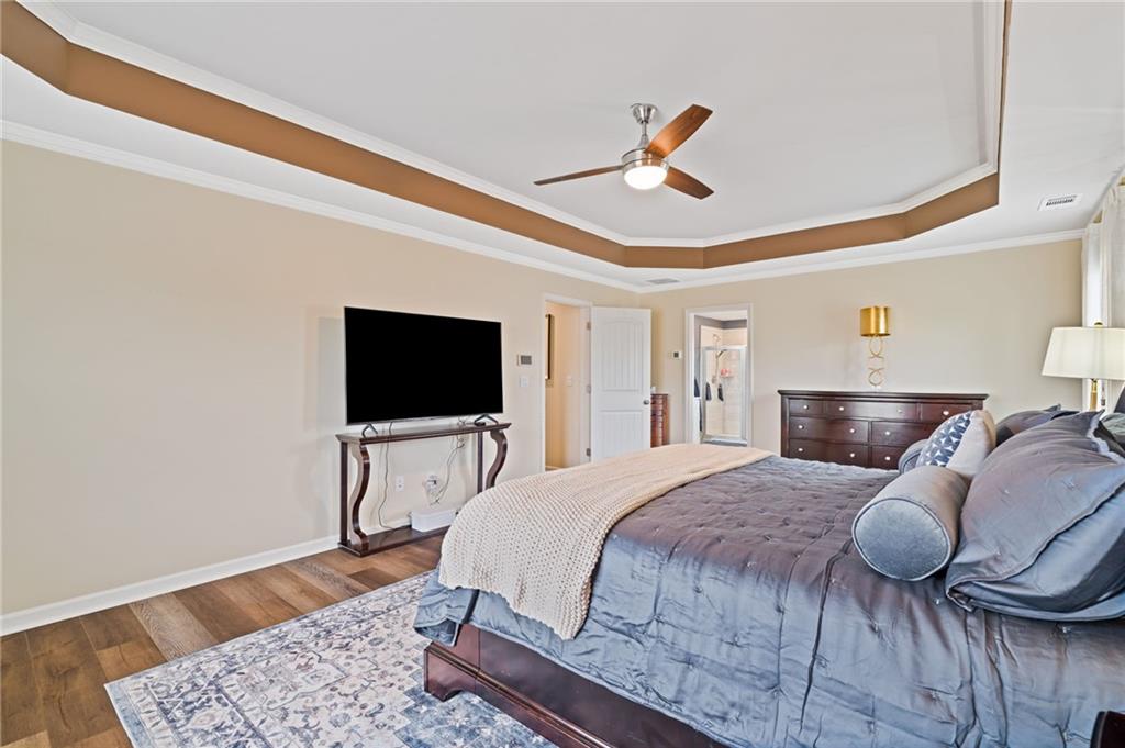 304 Ellenton Place Canton, GA 30115 - Photo 49 of 76 a bedroom with a bed and a flat screen tv